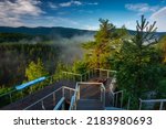 Misty sunrise on the Golden View terrace in the Jizera Mountains with a view of the Karkonosze Mountains. Poland