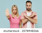 Young sad couple two friends family man woman in casual clothes showing stop palm hand gesture together isolated on pastel plain light blue color background studio portrait People lifestyle concept