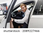 Small photo of Man happy customer male buyer client in shirt get out car touch door look camera salon drive choose auto want buy new automobile in showroom vehicle dealership store motor show indoor Sales concept