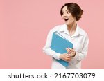 Young successful employee business secretary woman corporate lawyer in classic white shirt work in office hold blue folder for papers document bookkeeping look aside isolated on pastel pink background