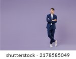 Small photo of Full size happy young successful employee business man lawyer 20s wear formal blue suit white t-shirt work in office hold hands crossed look aside isolated on pastel purple background studio portrait