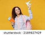 Small photo of Traveler fun happy black teen girl student wear casual clothes hold passport tickets airplane isolated on plain yellow background. Tourist travel high school study abroad getaway. Air flight concept