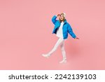 Small photo of Snowboarder woman wear blue suit goggles mask hat ski padded jacket walk go look far away hold hand at forehead isolated on plain pastel pink background. Winter extreme sport hobby trip relax concept