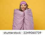 Small photo of Fun young happy cheerful woman she wearing pyjamas jam sleep eye mask wrapped in duvet blanket wink rest relax at home isolated on plain yellow background studio portrait. Good mood night nap concept