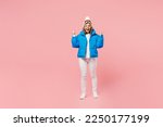 Snowboarder excited happy fun woman wear blue suit goggles mask hat ski padded jacket do winner gesture isolated on plain pastel pink background. Winter extreme sport hobby weekend trip relax concept