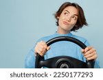 Small photo of Young minded wistful caucasian woman wear knitted sweater look camera hold steering wheel driving car look aside on workspace area isolated on plain pastel light blue cyan background studio portrait