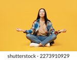 Small photo of Full body young woman wears blue shirt beige t-shirt hold spreading hands in yoga om aum gesture relax meditate try to calm down isolated on plain yellow background studio. People lifestyle concept