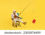 Small photo of Full body happy surprised young woman sit hold fishing rod with sale text isolated on plain yellow background. Tourist leads active lifestyle walk on spare time. Hiking trek rest travel trip concept
