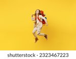 Full body young woman carry bag with stuff mat jump high look aside on area isolated on plain yellow background. Tourist leads active lifestyle walk on spare time. Hiking trek rest travel trip concept