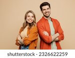 Small photo of Side view young smiling happy fun cool couple two friends family man woman wear casual clothes hold hands crossed folded together isolated on pastel plain light beige color background studio portrait