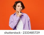 Small photo of Young caucasian woman she wearing purple shirt white t-shirt casual clothes say hush be quiet with finger on lips shhh gesture isolated on plain orange background studio portrait. Lifestyle concept