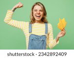 Small photo of Sick ill allergic woman has red watery eyes runny stuffy sore nose suffer from allergy trigger symptoms hay fever hold napkin showing biceps muscles isolated on plain green background studio portrait
