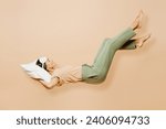 Small photo of Full body side view young calm Latin woman wears pyjamas jam sleep eye mask rest relax at home fly up hover over air fall down on pillow isolated on plain beige background. Good mood night nap concept