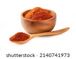 Paprika powder ( bell pepper) in wooden bowl and spoon isolated on white background.