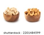 Cashew nuts and roasted cashew nuts in wooden bowl isolated on white background.