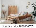 Bedroom interior in Bohemian style with patterned bed. Home interior detail in Boho style
