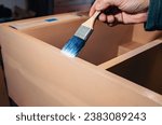 Small photo of The brush applies varnish to furniture. Varnishing furniture with varnish