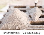 Cement or mortar, cement powder with a trowel and  cement powder pile put on the brick for construction work.