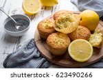 Homemade lemon poppy seed muffins on light rustic background
