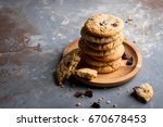 Stacked peanut butter cookies with chocolate chunks on concrete background 