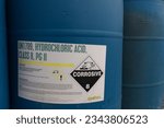 Small photo of HOUSTON, TEXAS - March, 2022: Hydrochloric acid plastic canisters with Corrosive safety information.