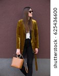 Small photo of perfect spring fashion outfit. european fashion blogger wearing a trendy mustard velvet blazer, black jeans, fishnet stockings and black loafers. holding a stylish handbag.