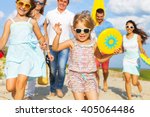 Multiracial group of friends with children walking at the beach