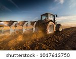 Tractor plowing fields -preparing land for sowing