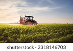 Tractor spraying pesticides on...