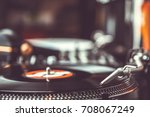 DJ turntable playing record with music on a hip hop party. Djs gear at a radio station