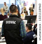Small photo of AUSTIN, TEXAS - MARCH 11, 2018: SXSW South by Southwest Annual music, film, and interactive conference and festival. Austin Convention Center, Event operation staff, SXSW sign on uniform.