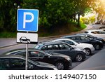 Parking sign. Vehicles take up way too much space in cities. Metropolis parking problems. Crowded parking.  Cars became biggest problem for urban ecology due emission and environmental pollution.