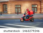 Delivery boy of takeaway on scooter with isothermal food case box driving fast. Express food delivery service from cafes and restaurants. Courier on the moto scooter delivering food.