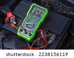 Small photo of Measurement of car battery voltage. Good car battery, almost fully charged voltage - 12.5V. Battery capacity tester voltmeter. Check voltage with multimeter. Test battery health