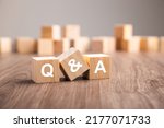 Three wooden cubes with the letters Q and A. questions and answers Q And A concept
