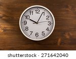 Wall Clock On Wooden Background