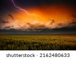 Small photo of Lightning illuminates ominous storm clouds over farmland. Adverse weather conditions. Location place agricultural region of Ukraine, Europe. Wallpaper force of nature. Discover the beauty of earth.