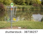 A frisbee golf target with discs in the basket.