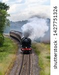Small photo of Wyre Piddle, Worcestershire, England on June 15 2019. Flying Scotsman Steam train travelling between Worcester and London Paddington