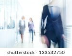 businesspeople walking in the corridor of an business center, pronounced motion blur