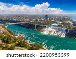 Panoramic aerial view of Canadian side view of Niagara Falls, American Falls and Rainbow International Bridge in a sunny day  in Niagara Falls, Ontario, Canada