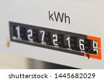 Small photo of Close up of electric meter reader showing used kWh in private residential home with selective focus