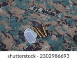 US MARINES camouflage uniform with ammunitions and dog tags background