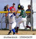 Small photo of SHERBROOKE, CANADA - August 7: Alberta's Mackenzie Bender and New Brunswick's Abagail Macgowan compete in women's softball at the Canada Games August 7, 2013 in Sherbrooke, Canada.