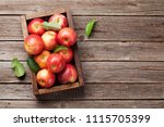 Ripe red apples in wooden box....
