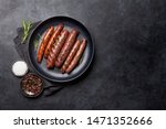 Grilled sausages with rosemary herbs. Top view with copy space