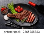 Small photo of Medium rare grilled Tomahawk beef steak with asparagus. Flat lay