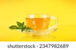 Small photo of Soothing herbal tea blend with mint. On yellow background
