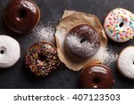 Colorful donuts on stone table. Top view