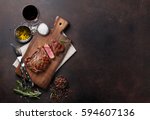 Grilled ribeye beef steak with red wine, herbs and spices. Top view with copy space for your text